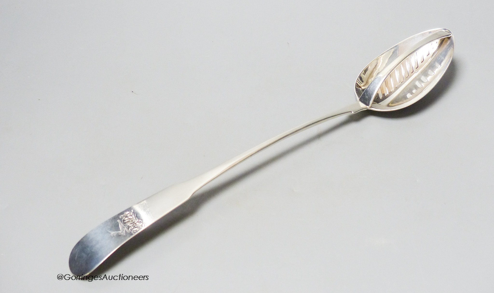 An early George III Irish silver fiddle pattern basting spoon, with strainer, Dublin, 1763, 33.9cm, 4oz.